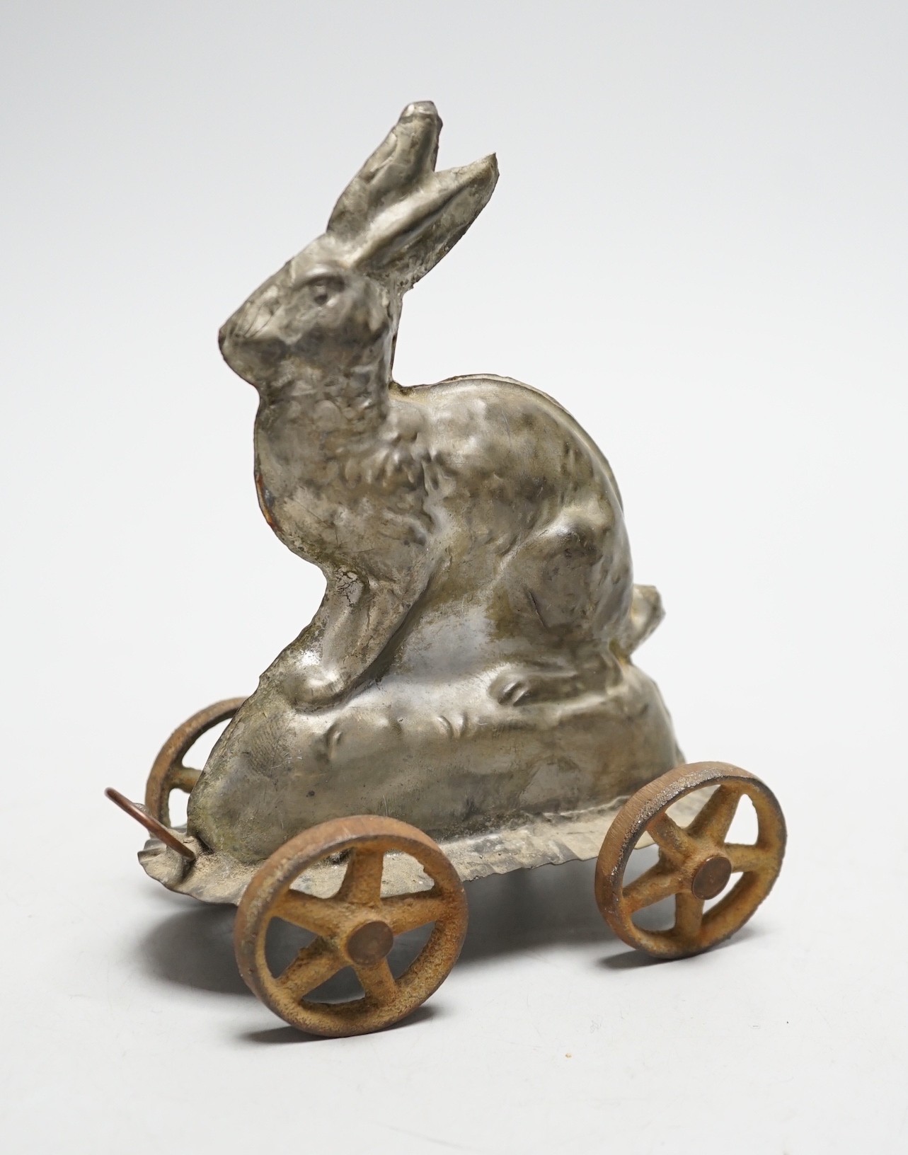 A late Victorian / Edwardian confectioners’ rabbit shaped mould, on four wheels, 15cm tall